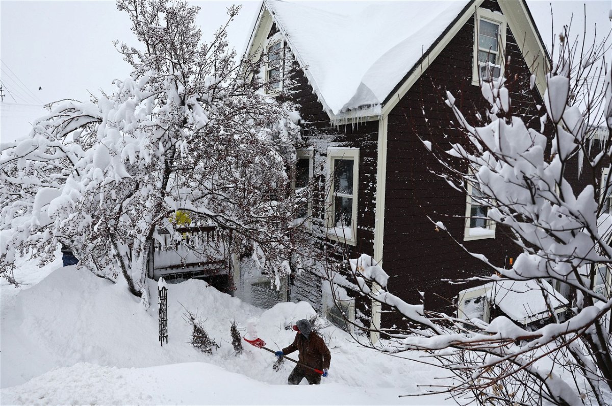 <i>Mario Tama/Getty Images via CNN Newsource</i><br/>A worker digs out snow from a home north of Lake Tahoe during a powerful multiple day winter storm in the Sierra Nevada on March 02