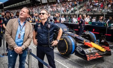 Jos Verstappen and Christian Horner stand on the grid in Austria last year.
