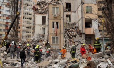 People visit the remnants of the building that was struck by a Russian drone in Odesa