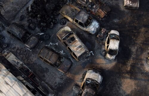 Charred vehicles sit at an auto body shop after the property was burned by the Smokehouse Creek Fire on Wednesday