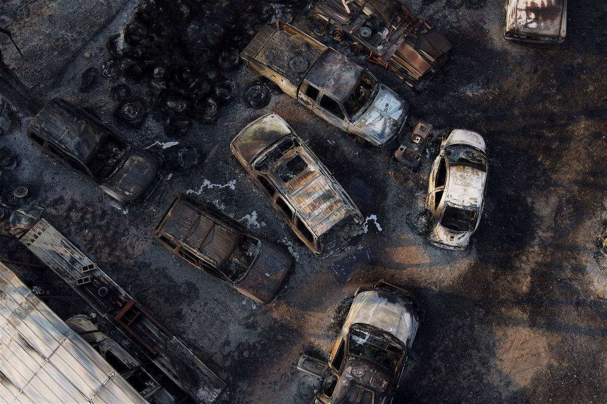 <i>Julio Cortez/AP via CNN Newsource</i><br/>Charred vehicles sit at an auto body shop after the property was burned by the Smokehouse Creek Fire on Wednesday