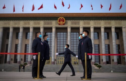 Soldiers dressed as ushers stand guard outside the Great Hall of the People ahead of the opening of the National People's Congress (NPC) in Beijing.