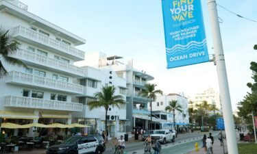 A police car cruises Ocean Drive February 27 in Miami Beach