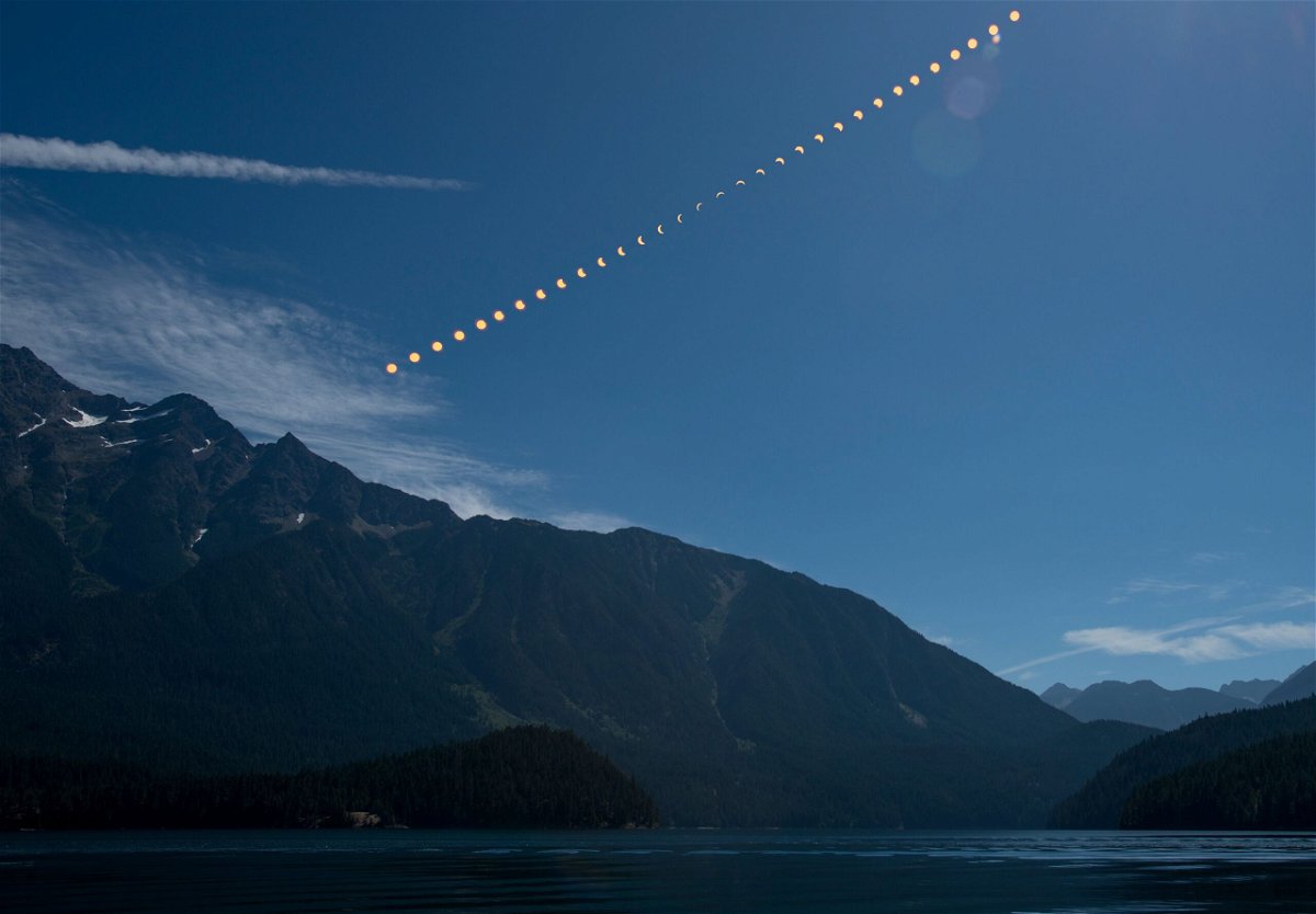 <i>Bill Ingalls/NASA via CNN Newsource</i><br/>This composite image shows the progression of a partial solar eclipse over Ross Lake in Northern Cascades National Park in Washington on August 21