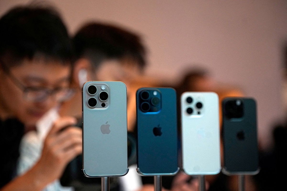 <i>Aly Song/Reuters via CNN Newsource</i><br/>People look at the new iPhone 15 Pro as Apple's new iPhone 15 officially goes on sale across China at an Apple store in Shanghai