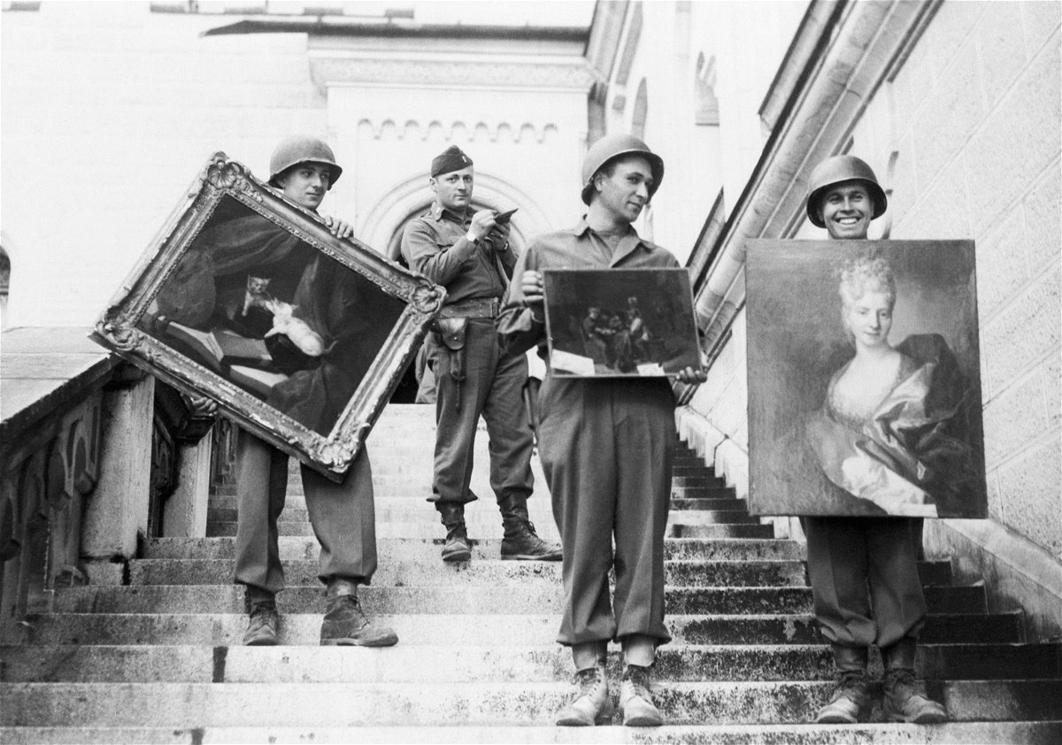 <i>Bettmann Archive/Getty Images via CNN Newsource</i><br/>US army soldiers carry three valuable paintings down the steps of Neuschwanstein Castle at Fussen