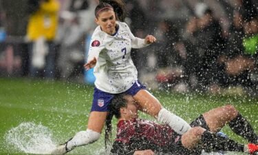 Alex Morgan of the US collides with Canada's Vanessa Gilles.