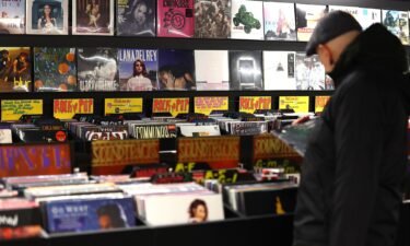 A customer looks through a rack of vinyl records at the HMV store on London's Oxford Street in December 2023.