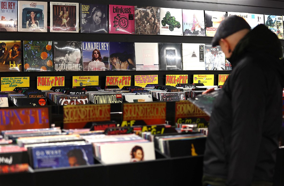 <i>Peter Nicholls/Getty Images via CNN Newsource</i><br/>A customer looks through a rack of vinyl records at the HMV store on London's Oxford Street in December 2023.