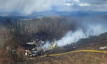 An emergency crew works at the site of a plane crash in Hot Springs