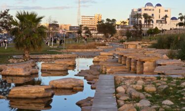 People walk near a park along the seaside corniche in Libya's capital Tripoli on February 22.