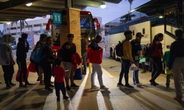 Migrants board a bus to Chicago