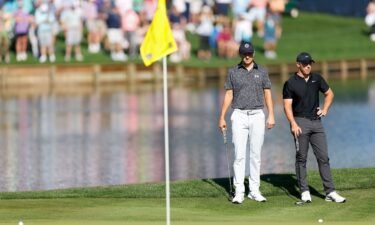 Spieth [left] and McIlroy look on at the 16th green.