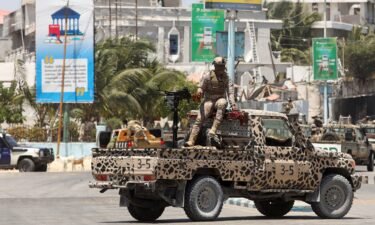 A Somali security officer holds a position on a truck near Syl Hotel