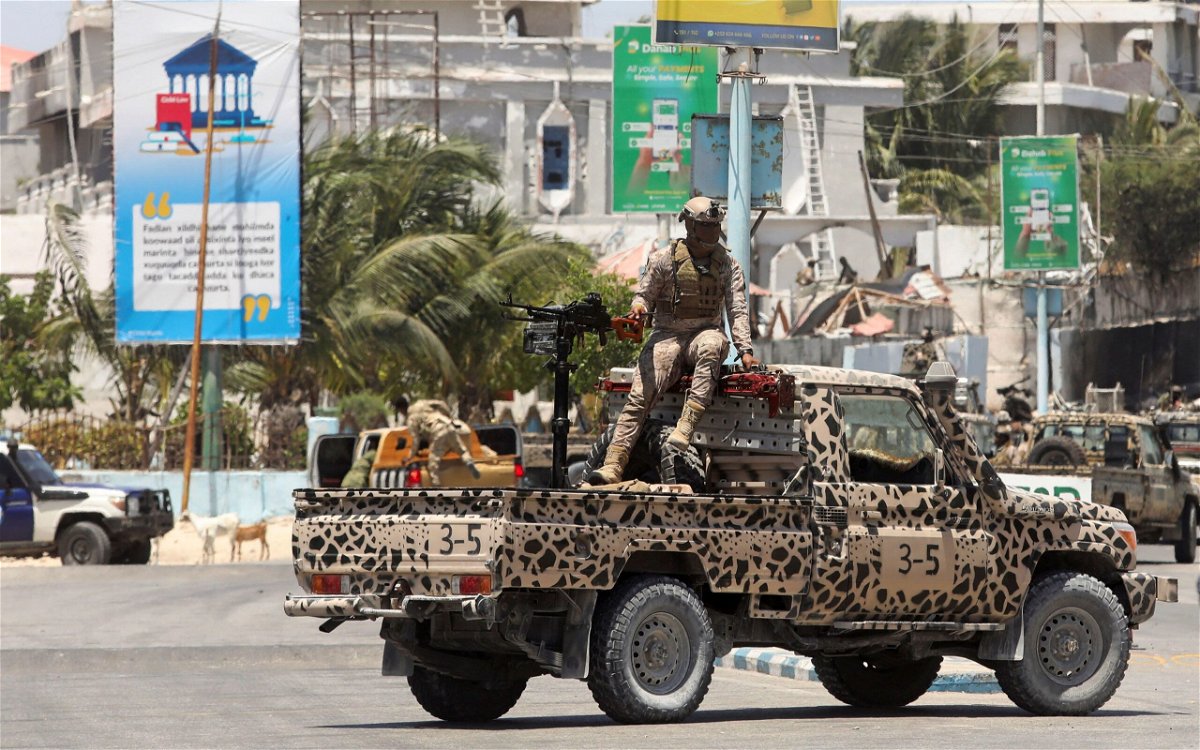 <i>Feisal Omar/Reuters via CNN Newsource</i><br/>A Somali security officer holds a position on a truck near Syl Hotel