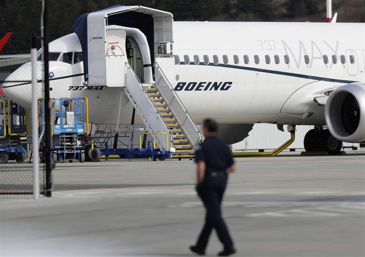 <i>Ted S. Warren/AP via CNN Newsource</i><br/>A worker walks next to a Boeing 737 MAX 8 airplane parked at Boeing Field in Seattle