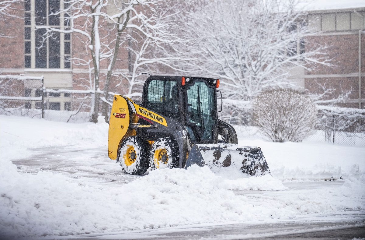 <i>Scott Ash/Milwaukee Jourrnal/USA Today via CNN Newsource</i><br/>A skid steer clears a driveway in Pewaukee on Friday morning after a spring storm dumped snow across the area.