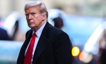 Former US President Donald Trump arrives at 40 Wall Street after his court hearing to determine the date of his trial for allegedly covering up hush money payments in New York City on March 25.