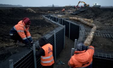 Workers inspect fortifications being built in Ukraine's Sumy region on March 16. The city of Sumy
