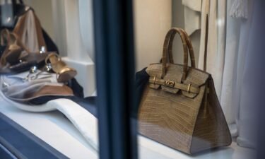 A Birkin luxury handbag sits in the window display of a Hermes International store in Paris