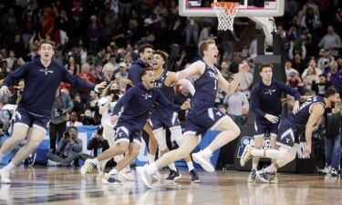 Yale players celebrate after their win over Auburn in the first round of the NCAA men's basketball tournament in Spokane