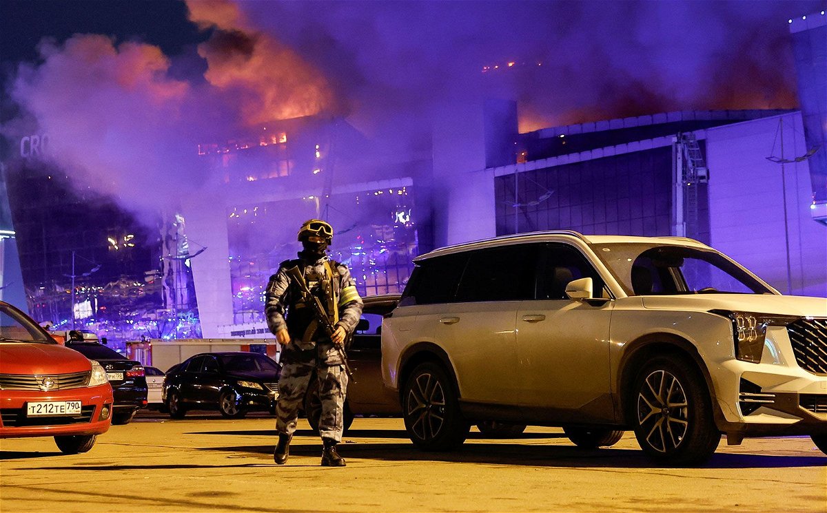 <i>Maxim Shemetov/Reuters via CNN Newsource</i><br/>Vehicles of Russian emergency services near the burning Crocus City Hall concert venue following the attack on March 22.