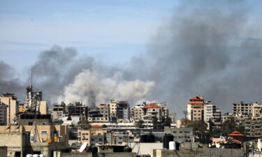 Palestinian residents leave the area with a few items after Israeli forces besiege the Al-Shifa hospital with tanks and heavy gunfire in Gaza City