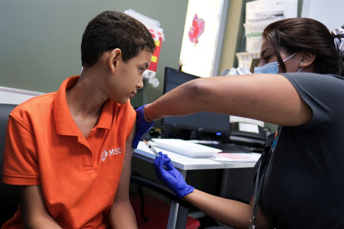 <i>Ricardo Arduengo/Reuters via CNN Newsource</i><br/>A registered nurse injects a dose of the dengue vaccine to Alberto Luis Nunez