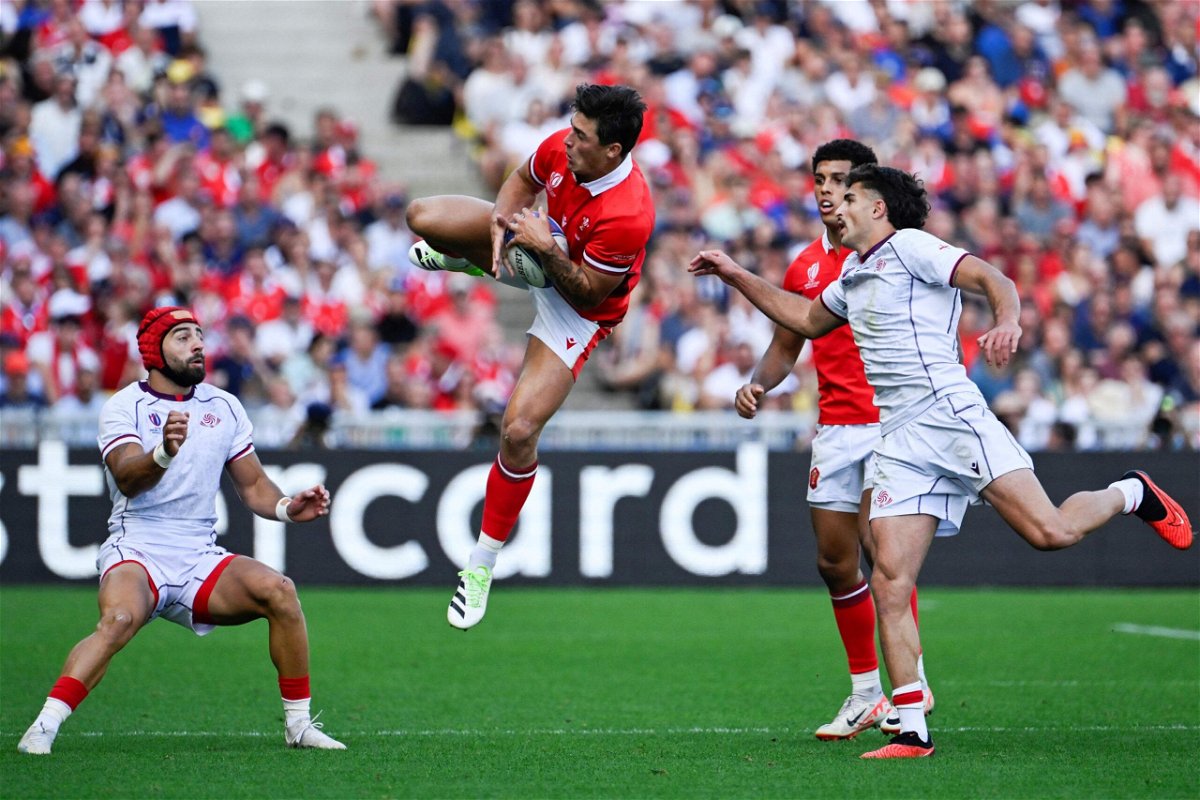 <i>Damien Meyer/AFP/Getty Images via CNN Newsource</i><br/>Wales' wing Louis Rees-Zammit (C) leaps to catch a high ball during the France 2023 Rugby World Cup Pool C match between Wales and Georgia at the Stade de la Beaujoire in Nantes