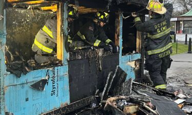 This handout photo released by DC Fire and EMS shows officers working on a kiosk that was burned near the Lincoln Memorial in Washington