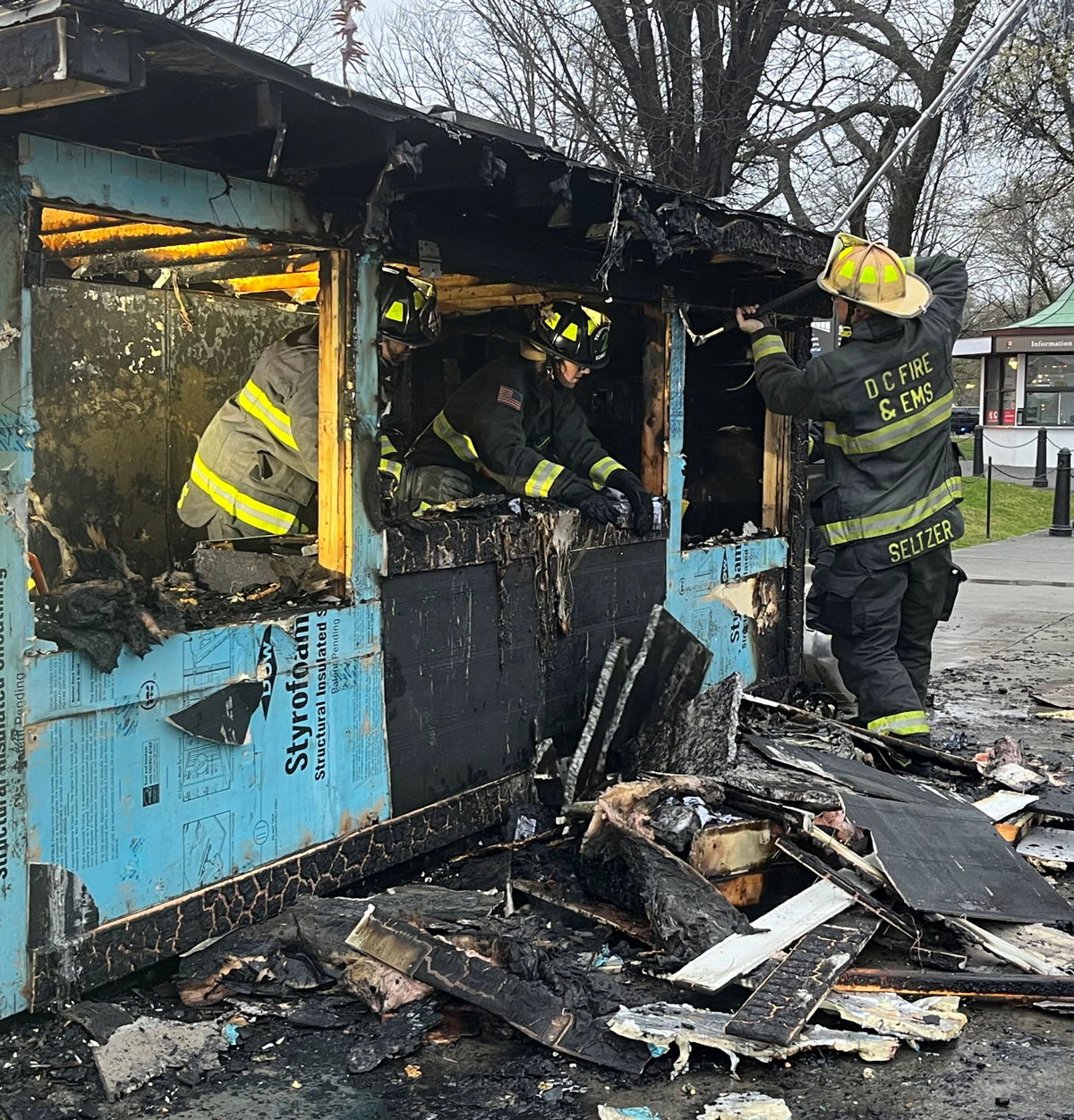 <i>From DC Fire and EMS via CNN Newsource</i><br/>This handout photo released by DC Fire and EMS shows officers working on a kiosk that was burned near the Lincoln Memorial in Washington