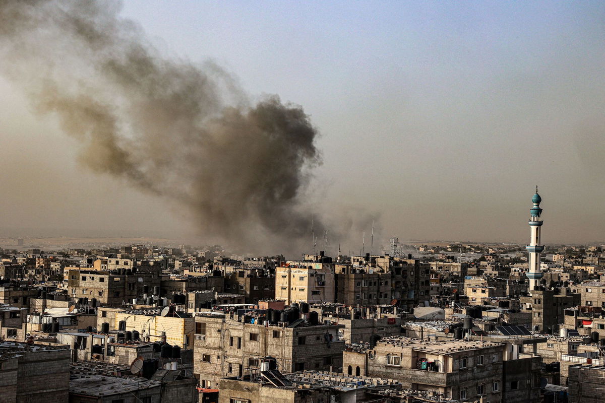 <i>Said Khatib/AFP/Getty Images via CNN Newsource</i><br/>Smoke billows over buildings following Israeli bombardment in Rafah in the southern Gaza Strip on March 27