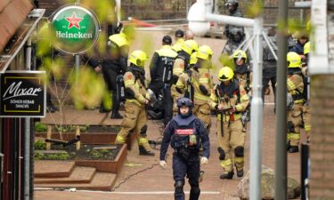 Police and emergency services are seen amid the hostage incident in Ede on Saturday.