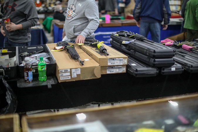 People browse guns for sale, during the Novi Gun and Knife Show at Suburban Collection Showplace in Novi, Michigan, on February 24, 2018.