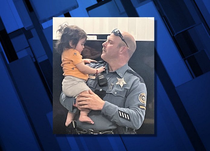 OSP Sgt. OJ Johnson with rescued 1-year-old Roman Santos