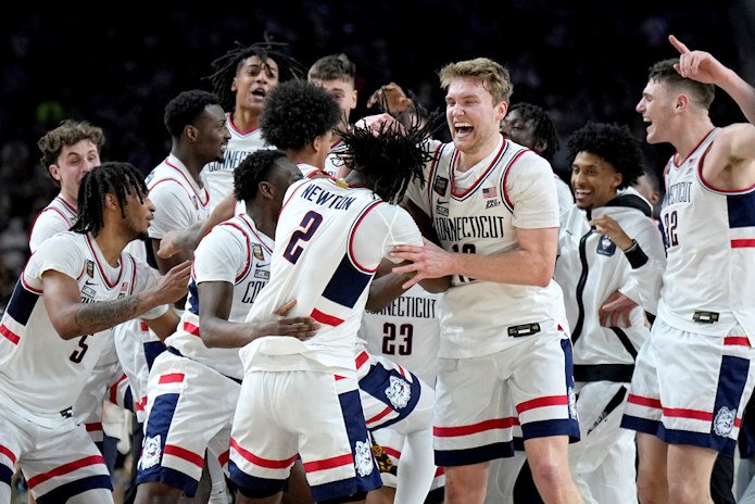 UConn players celebrate as time expires during the second half of the NCAA college Final Four championship basketball game against Purdue, Monday night in Glendale, Ariz. 
