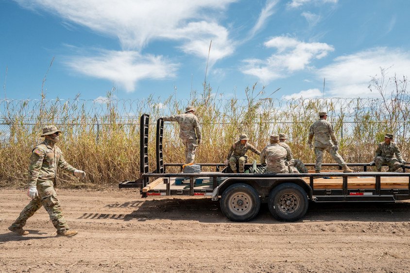 Texas National Guard soldiers repair damaged fencing on the banks of the Rio Grande in Eagle Pass, Texas, on March 21.
