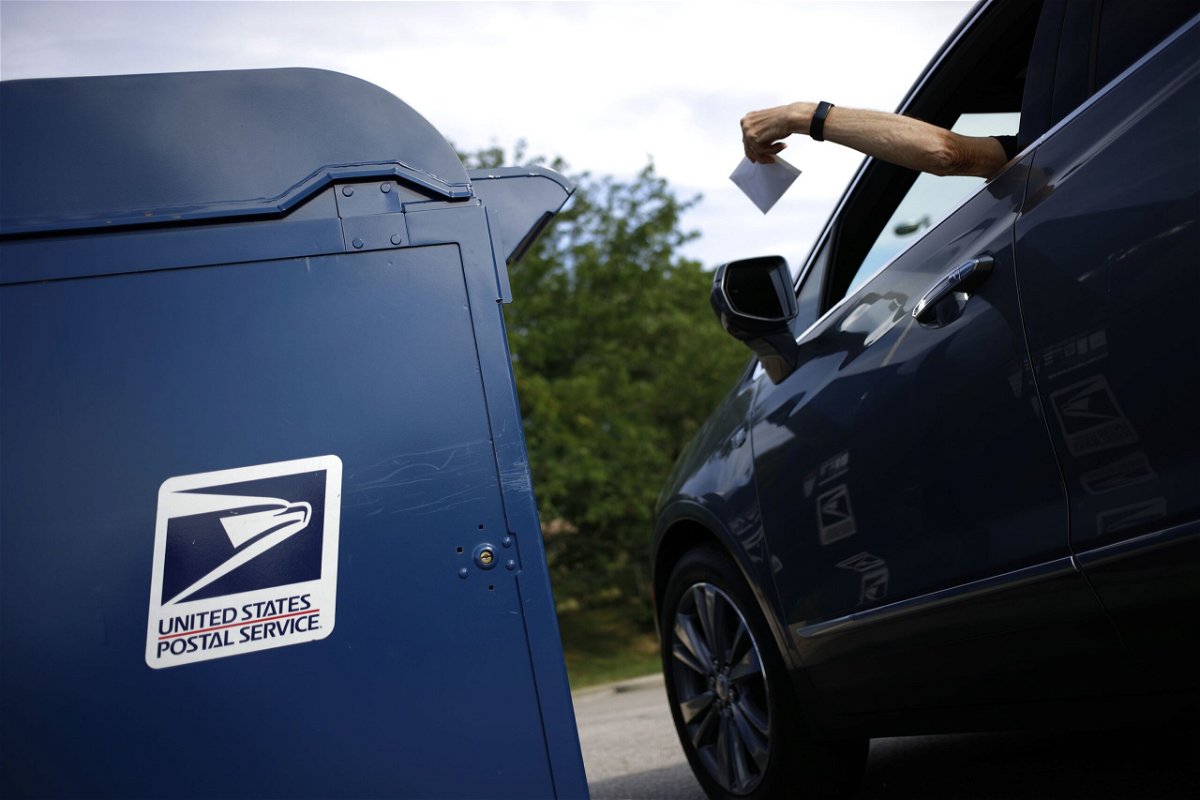 <i>Luke Sharrett/Bloomberg/Getty Images via CNN Newsource</i><br/>A motorist drops a letter into a USPS mail drop box at a post office in Kentucky in 2022.