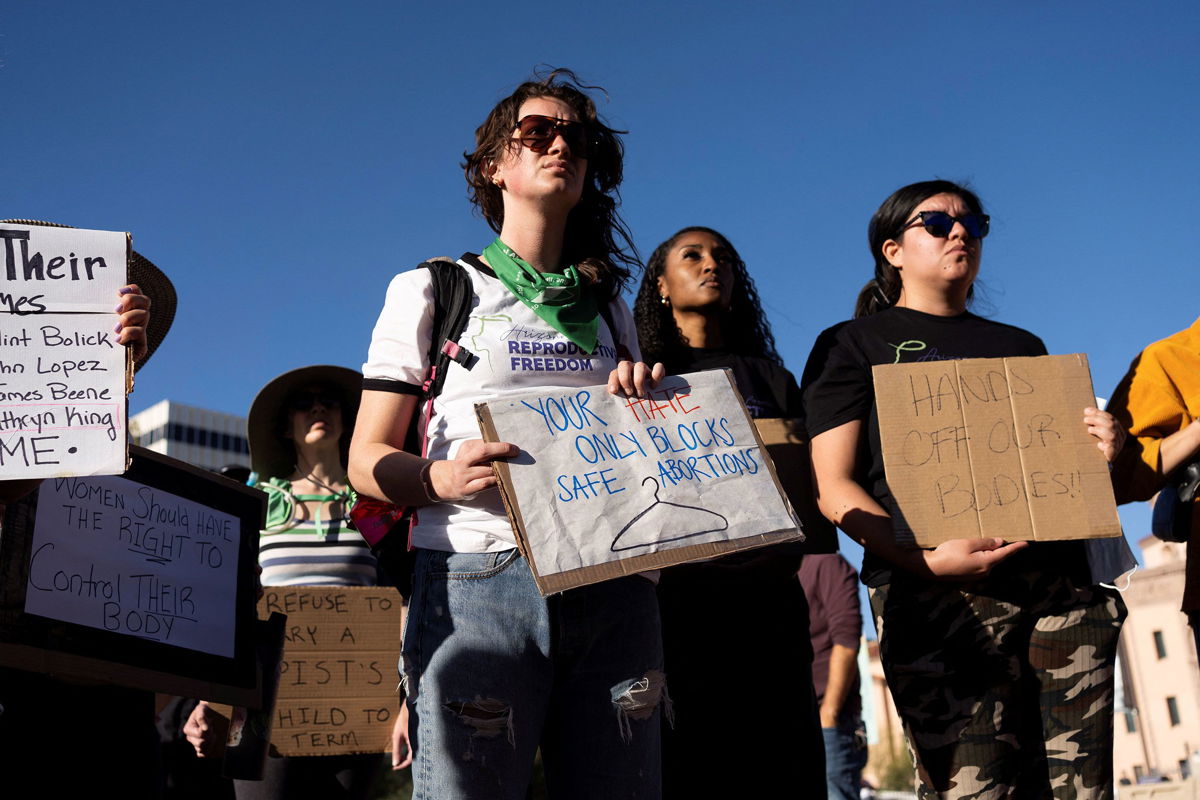 <i>Rebecca Noble/Reuters via CNN Newsource</i><br/>Protesters take part in a rally in Tucson