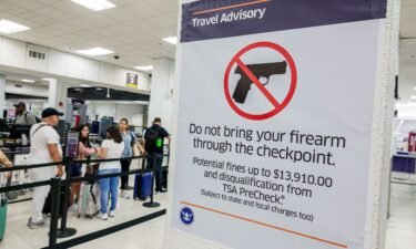 A sign at Miami International Airport's security screening lays out the consequences of trying to bring a firearm through the checkpoint.