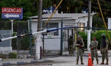 Members of Ecuador's Navy stand at the entrance of the hospital where Ecuador's detained former vice president Jorge Glas was taken after falling ill at a prison following his arrest.