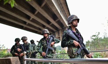 Members of a Myanmar militia are seen across the Moei river on the Myanmar side