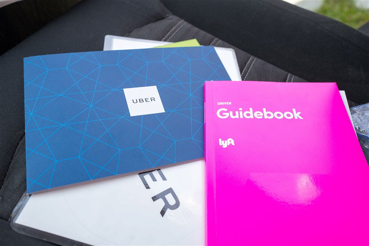 <i>Smith Collection/Gado/Getty Images via CNN Newsource</i><br/>New driver manuals for Uber and Lyft drivers are displayed in a 2018 photo.