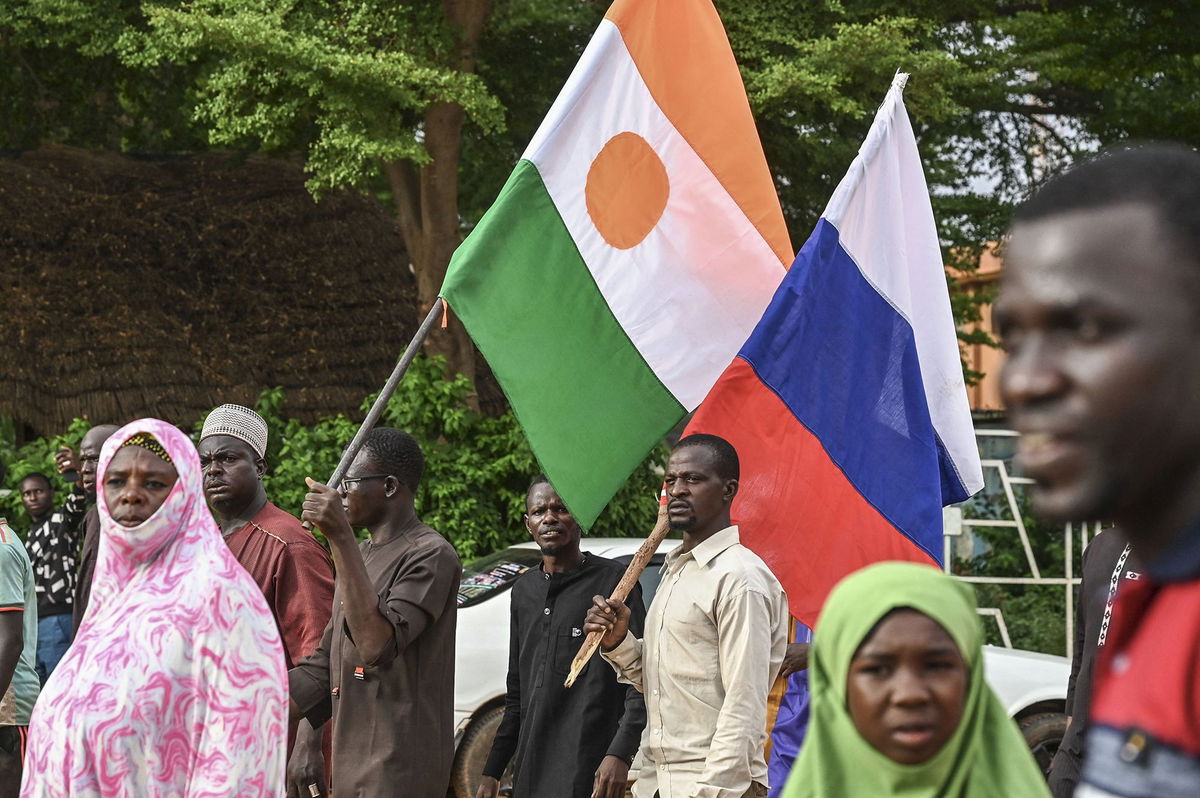 <i>AFP/Getty Images via CNN Newsource</i><br/>Supporters of Niger's National Council for Safeguard of the Homeland (CNSP) hold up Niger's national flag and the national flag of Russia at the General Seyni Kountche stadium in Niamey in Agust 2023.