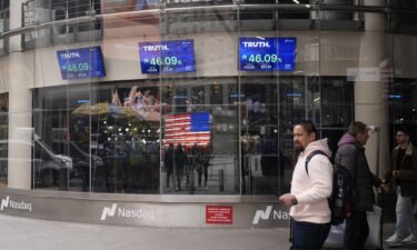 Pedestrians walk past the Nasdaq building on March 26 in New York. Anyone who bought Trump Media at the closing high of $66.22 on March 27 has now lost more than half of their money.