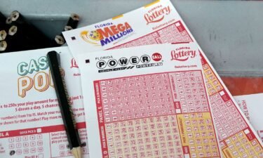 Forms to pick numbers for Powerball are on display in a store on October 4