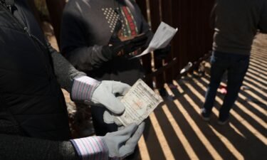 A Border Vets volunteer holds a Chinese Passport found at the US-Mexico border on February 29