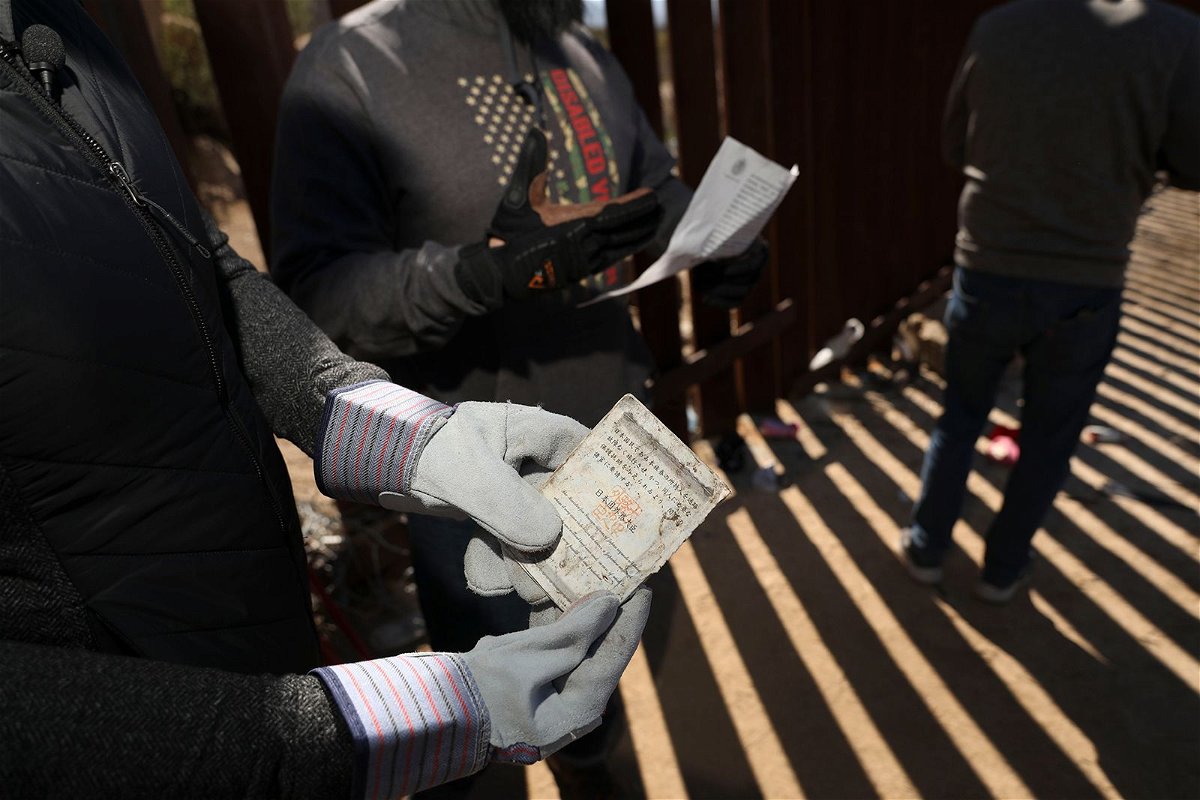 <i>Sandy Huffaker/Getty Images/File via CNN Newsource</i><br/>A Border Vets volunteer holds a Chinese Passport found at the US-Mexico border on February 29