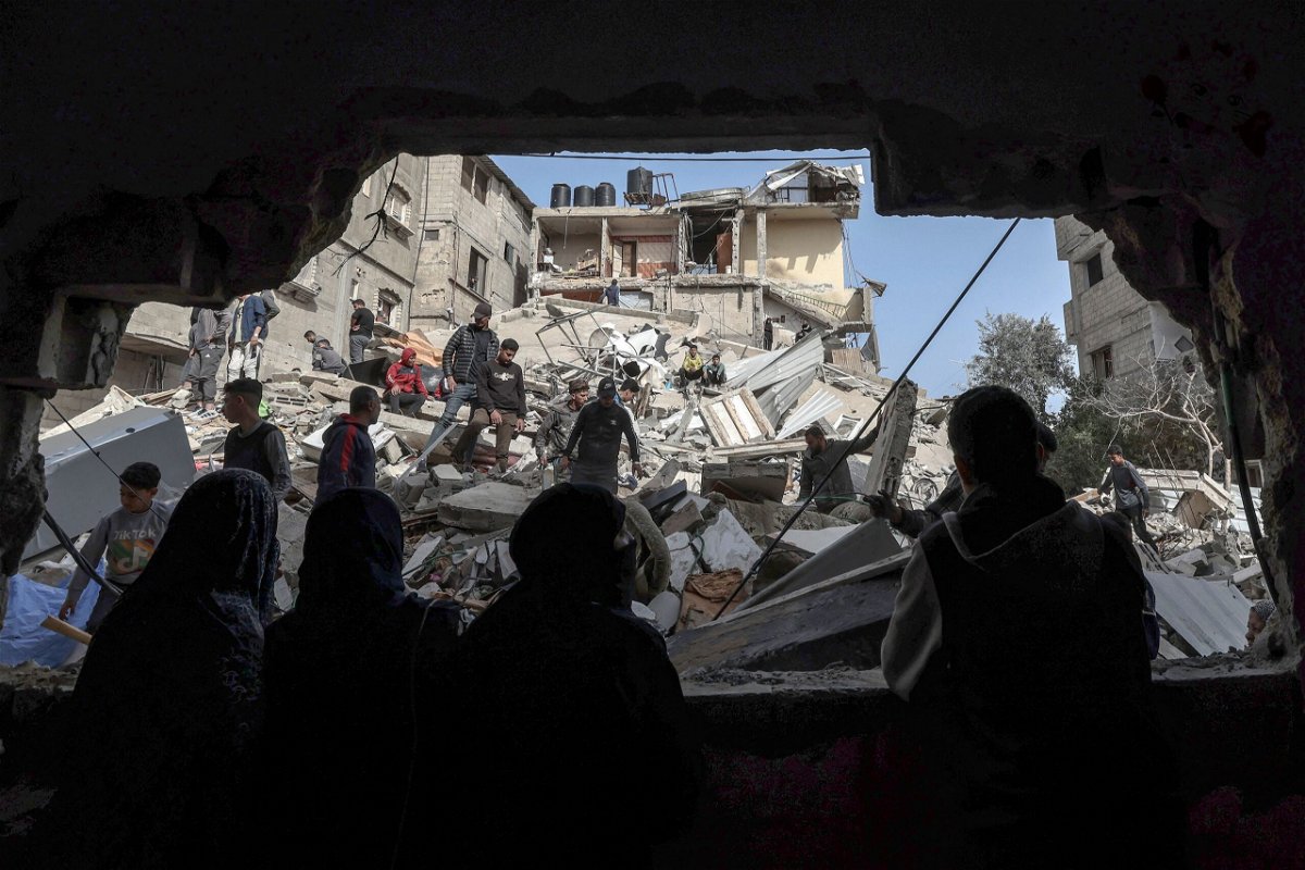 <i>Mohammed Abed/AFP/Getty Images via CNN Newsource</i><br/>Palestinians check the rubble of buildings that were destroyed following overnight Israeli bombardment in Rafah