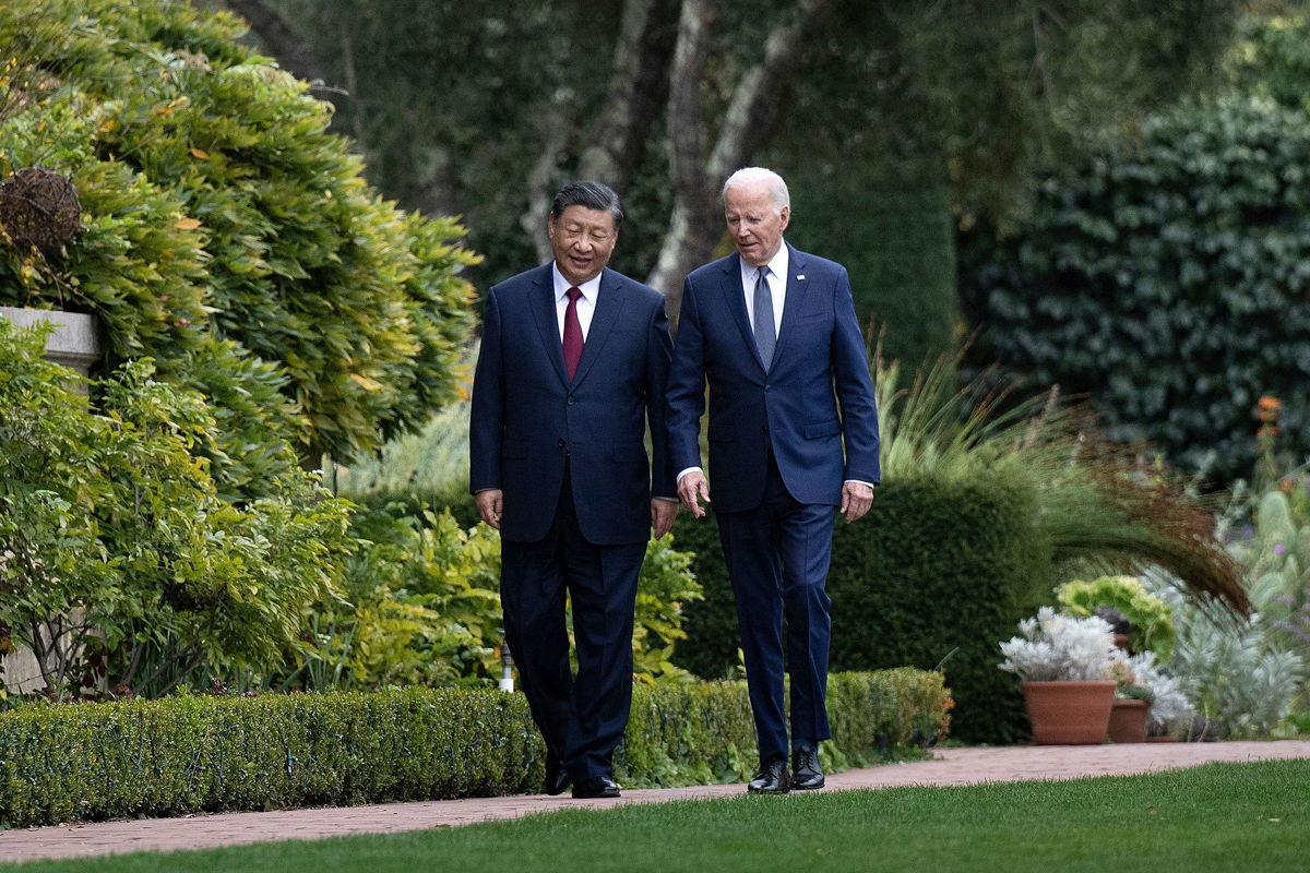 <i>Brendan Smialowski/AFP/Getty Images via CNN Newsource</i><br/>President Joe Biden and Chinese President Xi Jinping walk together after a meeting during the Asia-Pacific Economic Cooperation (APEC) Leaders' week in Woodside